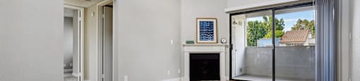 A room with a fireplace and a framed picture on the wall.