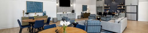 A modern dining room with a wooden table and blue chairs.