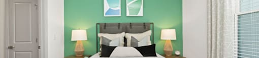 a bedroom with a large bed and two windows