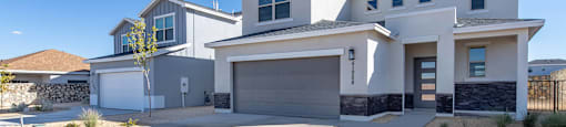 A modern two-story house with a garage and a driveway.