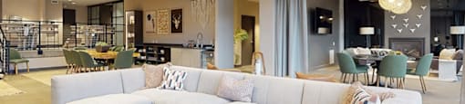 A modern living room with a large sectional sofa and a coffee table.