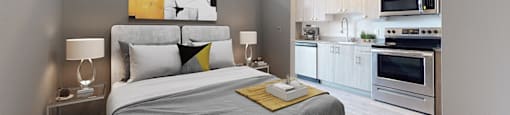 A bedroom with a bed, nightstands, and a kitchen area.