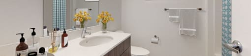 A bathroom with a white sink and a white toilet.