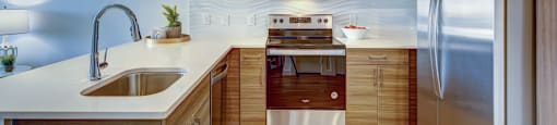kitchen with a sink and silver appliances at Brixton South Shore, Austin, Texas