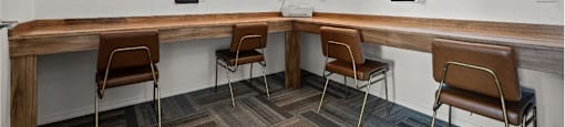 a long wooden table with chairs in a room