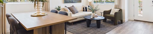 A modern living room with a dining table and a couch.