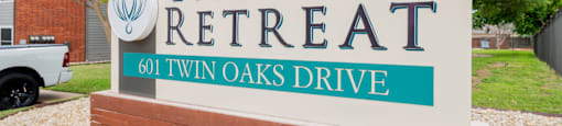 a sign that says the retreat 601 twin oaks drive