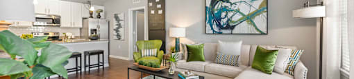 a living room with a couch coffee table and a ceiling fan