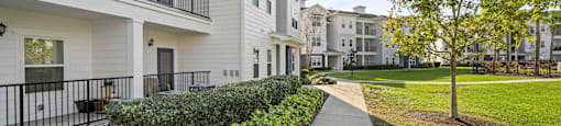 walkway and grassy area at the bradley braddock road station apartments