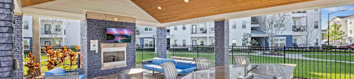 the estates at tanglewood|covered outdoor patio with fireplace