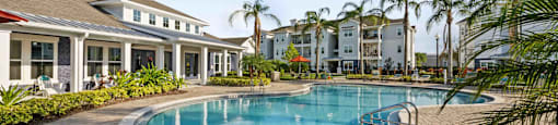 a large swimming pool in front of a building