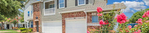 the front of a house with a driveway and a garage door