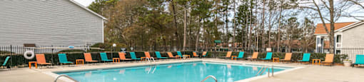 the swimming pool at our apartments has a resort style pool and lounge chairs