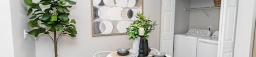 our apartments offer a dining room with a small table and chairs