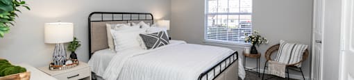 a bedroom with a bed and a ceiling fan