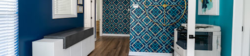 a living room with blue walls and a white door