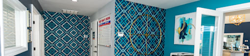 a dentist office with blue and white walls and wood floors