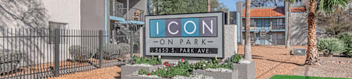 A sign for Icon Park Ave stands in front of a building.