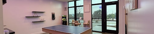 A conference room with a table and chairs.