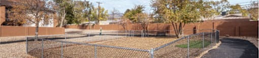a fenced in dog park with a chain link fence