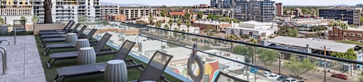 A row of grey chairs are lined up on a patio.