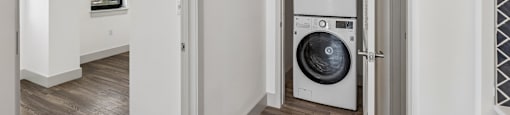 A modern laundry room with a washer and dryer.