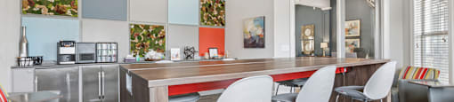 A modern kitchen with a dining table and chairs.
