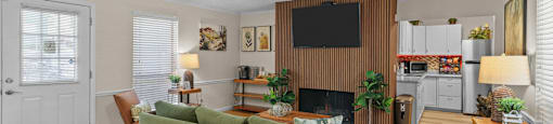 a living room with a green couch and a ceiling fan