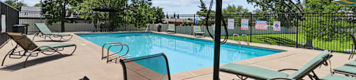 our apartments have a swimming pool with chairs and umbrellas