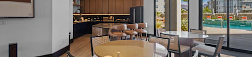 A modern dining room with a large table and chairs.