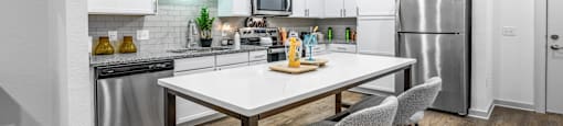 A modern kitchen with a dining table and chairs.