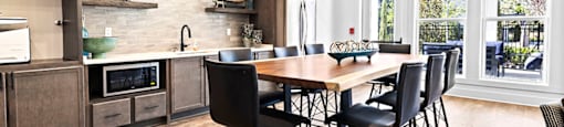 a large kitchen with a wooden table and chairs