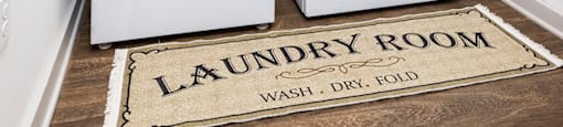 a washer and dryer in a laundry room with a rug