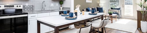 an open kitchen and living room with a table