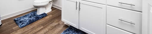 a bathroom with white cabinets and a toilet