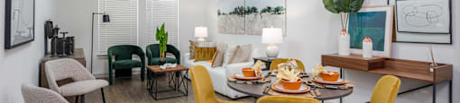 A dining room with a table set for six people.