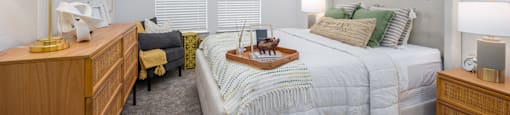 A bedroom with a large bed and a ceiling fan.