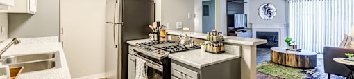 A modern kitchen with a large island and stainless steel appliances.