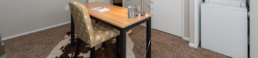 A small room with a desk and a chair.