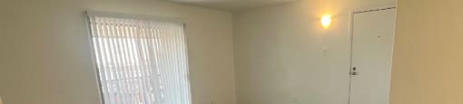 an empty living room with a sliding glass door