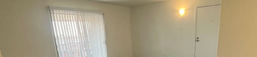 an empty living room with a sliding glass door
