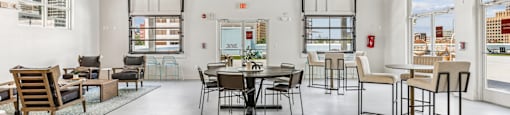 A large open space with a dining table and chairs.