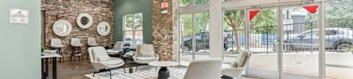 A room with a brick wall and a large window.