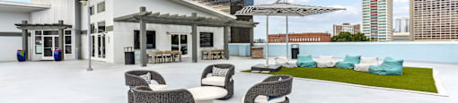 A white building with a patio area in front.