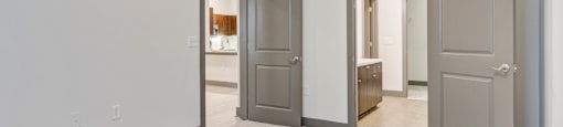 an empty room with three doors in a house