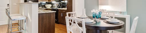 a kitchen and dining room with a table and chairs