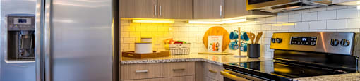 A kitchen with a stainless steel refrigerator and a microwave oven.
