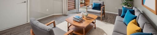 a living room with a couch and a table and a ceiling fan