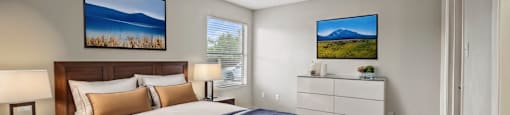 a bedroom with a bed and a dresser and a window