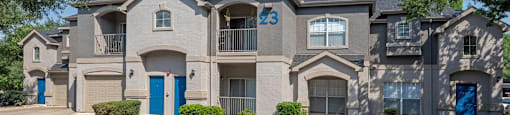 A large, modern house with the number 23 on the front.